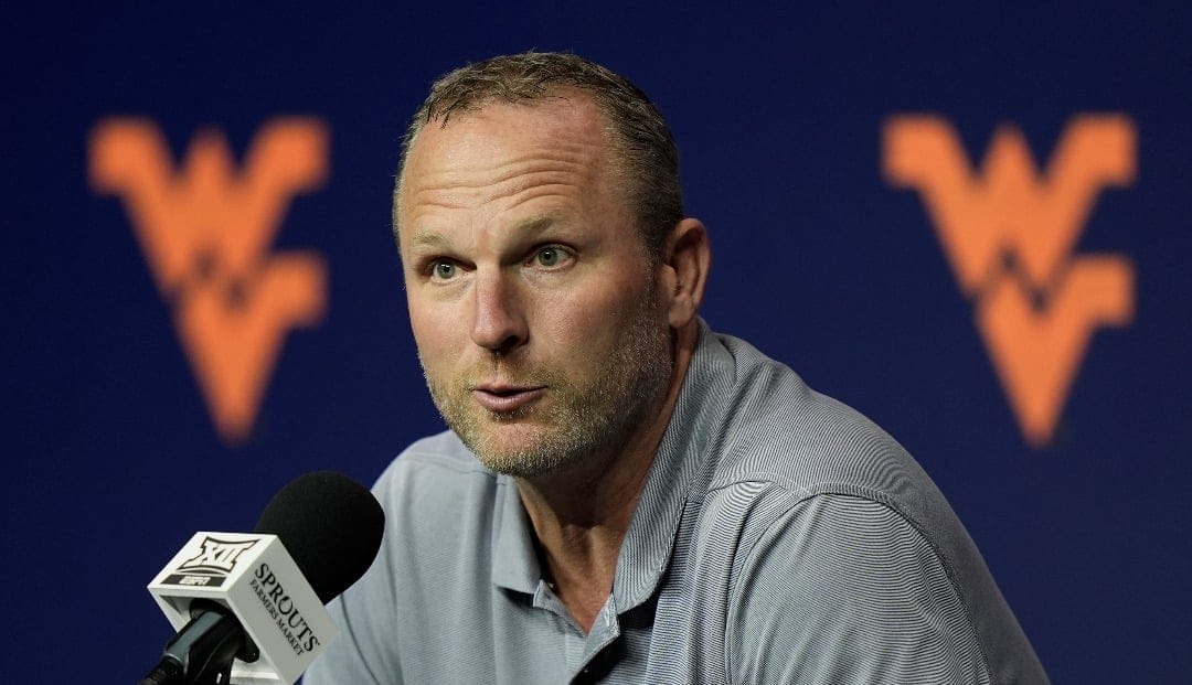 West Virginia head coach Darian DeVries addresses the media during the NCAA college Big 12 men's basketball media day, Wednesday, Oct. 23, 2024, in Kansas City, Mo. (AP Photo/Charlie Riedel)