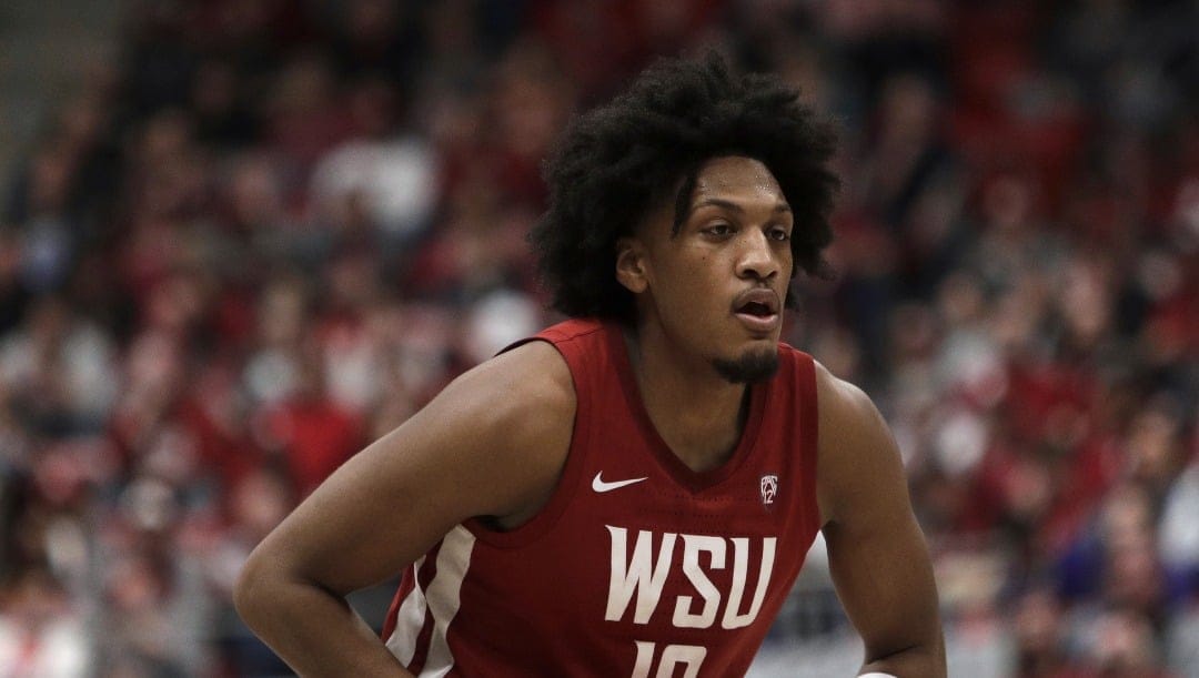 Washington State forward Isaac Jones controls the ball during the second half of an NCAA college basketball game against Washington, Thursday, March 7, 2024, in Pullman, Wash. (AP Photo/Young Kwak)