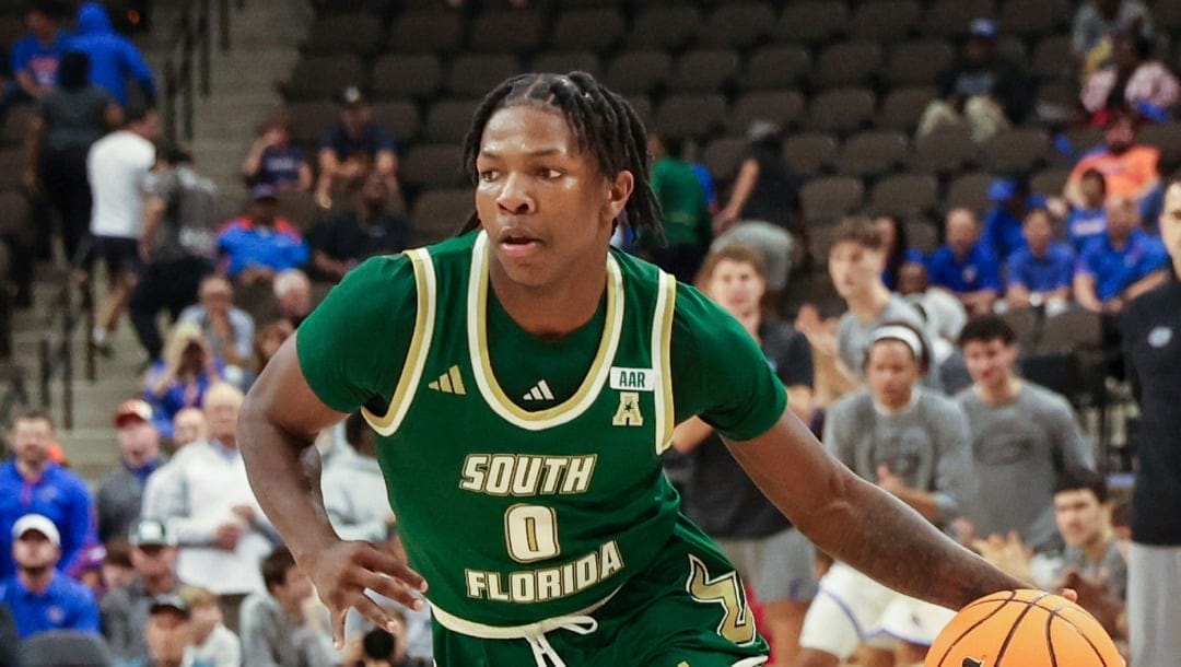 South Florida guard Jayden Reid (0) drives toward the basket during the second half of an NCAA college basketball game against Florida, Monday, Nov. 4, 2024, in Jacksonville, Fla. Florida defeated South Florida 98-83. (AP Photo/Gary McCullough)