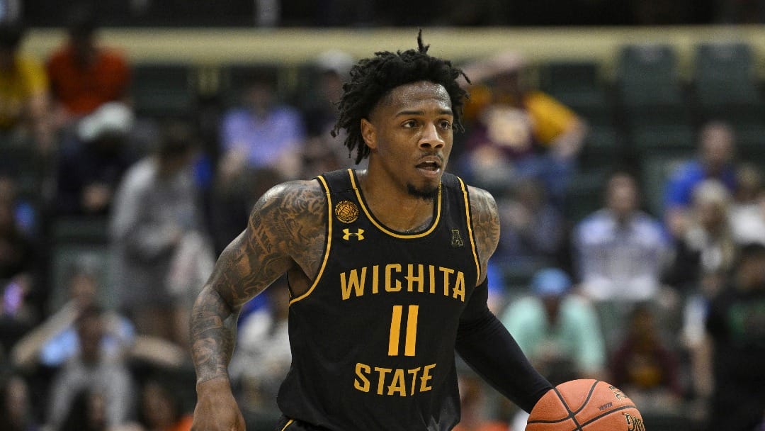 Wichita State guard Justin Hill (11) brings the ball up the court against Florida during the first half of an NCAA college basketball game, Friday, Nov. 29, 2024, in Kissimmee, Fla. (AP Photo/Phelan M. Ebenhack)