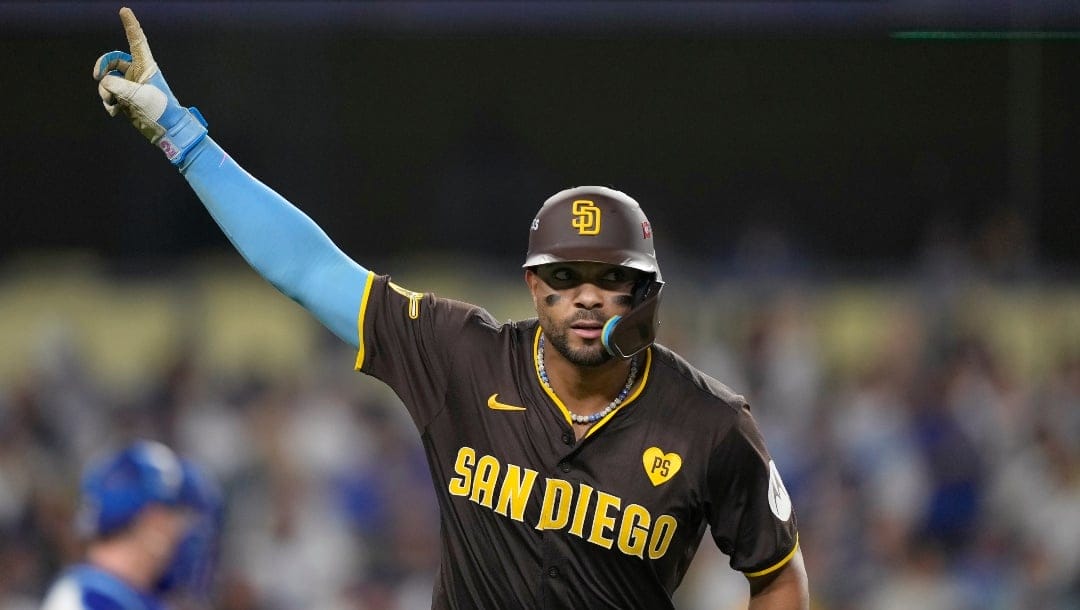 San Diego Padres' Xander Bogaerts celebrates after hitting a solo home run during the eighth inning in Game 2 of a baseball NL Division Series against the Los Angeles Dodgers, Sunday, Oct. 6, 2024, in Los Angeles.