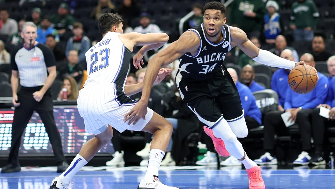 Giannis Antetokounmpo #34 of the Milwaukee Bucks drives around Tristan da Silva #23 of the Orlando Magic during a game in the NBA Emirates Cup Quarterfinal at Fiserv Forum on December 10, 2024 in Milwaukee, Wisconsin.