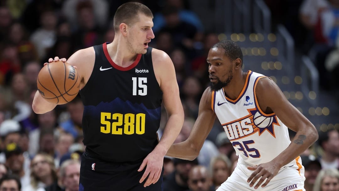 Nikola Jokic #15 of the Denver Nuggets is guarded by Kevin Durant #35 of the Phoenix Suns during the first quarter at Ball Arena on March 27, 2024 in Denver, Colorado.