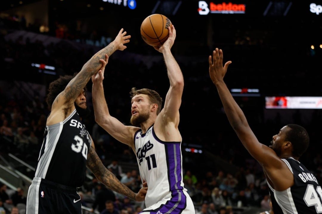 SAN ANTONIO, TX - DECEMBER 6: Domantas Sabonis #11 of the Sacramento Kings drives on Julian Champagne #30 of the San Antonio Spurs in the second half at Frost Bank Center on December 6, 2024 in San Antonio, Texas. NOTE TO USER: User expressly acknowledges and agrees that, by downloading and or using this photograph, User is consenting to terms and conditions of the Getty Images License Agreement.