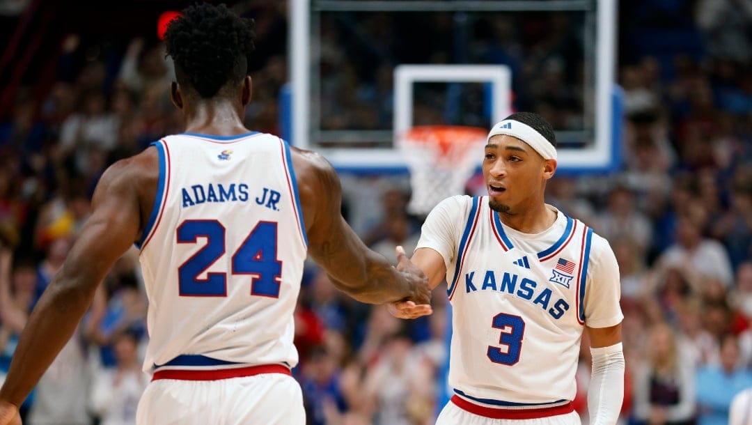 Kansas guard Dajuan Harris Jr. (3) congratulates Kansas forward KJ Adams Jr. (24) after scoring during the first half of an NCAA college basketball game against Howard, Monday, Nov. 4, 2024, in Lawrence, Kan.