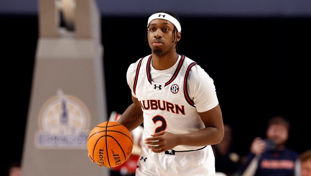 Auburn guard Denver Jones dribbles the ball during the first half of an NCAA college basketball game against Purdue, Saturday, Dec. 21, 2024, in Birmingham, Ala.