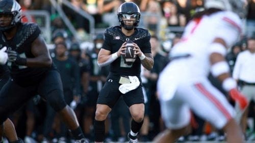 Oregon quarterback Dillon Gabriel, center, looks to pass the ball during an NCAA college football game against Ohio State, Saturday, Oct. 12, 2024, in Eugene, Ore.