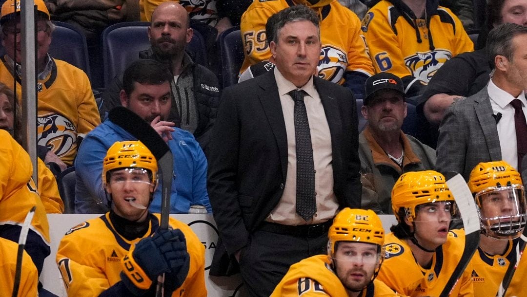 Nashville Predators head coach Andrew Brunette, center, during the first period of an NHL hockey game against the Calgary Flames, Tuesday, Dec. 10, 2024, in Nashville, Tenn.