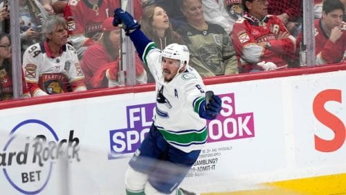 Vancouver Canucks center J.T. Miller celebrates after scoring during an overtime period of an NHL hockey game to beat the Florida Panthers 3-2, Thursday, Oct. 17, 2024, in Sunrise, Fla.