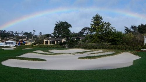 A rainbow is shown over a bunker on the 18th fairway at Pebble Beach Golf Links before the scheduled final round of the AT&T Pebble Beach National Pro-Am golf tournament in Pebble Beach, Calif., Sunday, Feb. 4, 2024. (AP Photo/Ryan Sun)