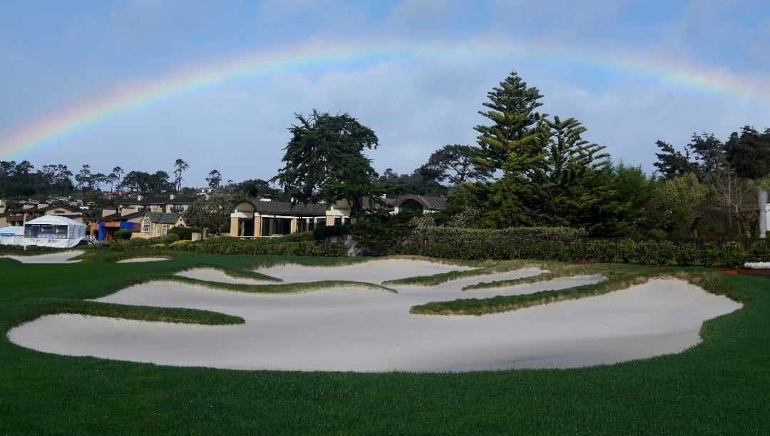 A rainbow is shown over a bunker on the 18th fairway at Pebble Beach Golf Links before the scheduled final round of the AT&T Pebble Beach National Pro-Am golf tournament in Pebble Beach, Calif., Sunday, Feb. 4, 2024. (AP Photo/Ryan Sun)