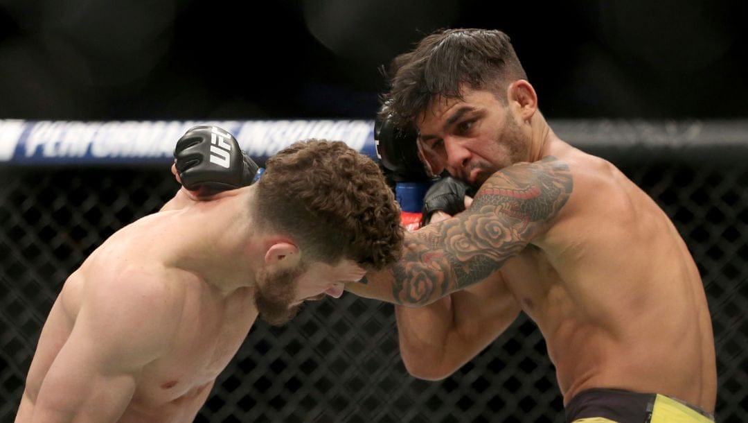 Dustin Ortiz, left, exchanges blows with Alexandre Pantoja during a mixed martial arts bout at UFC 220, Saturday.