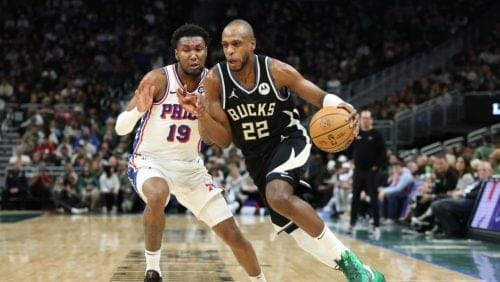 MILWAUKEE, WISCONSIN - JANUARY 19: Khris Middleton #22 of the Milwaukee Bucks drives around Justin Edwards #19 of the Philadelphia 76ers during the first half of a game at Fiserv Forum on January 19, 2025 in Milwaukee, Wisconsin. NOTE TO USER: User expressly acknowledges and agrees that, by downloading and or using this photograph, User is consenting to the terms and conditions of the Getty Images License Agreement.