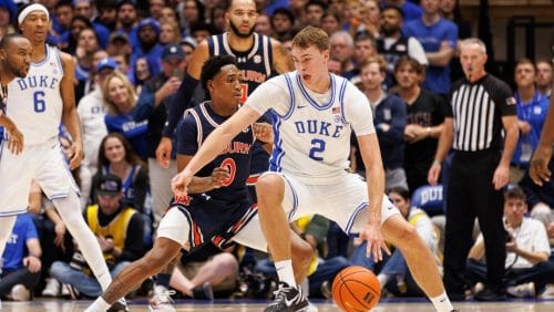 Duke's Cooper Flagg (2) handles the ball as Auburn's Tahaad Pettiford (0) defends during the first half of an NCAA college basketball game in Durham, N.C., Wednesday, Dec. 4, 2024.