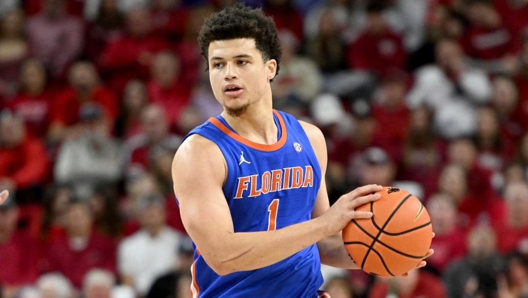 Florida guard Walter Clayton Jr. (1) runs a play against Arkansas during an NCAA college basketball game Saturday, Jan. 11, 2025, in Fayetteville, Ark.