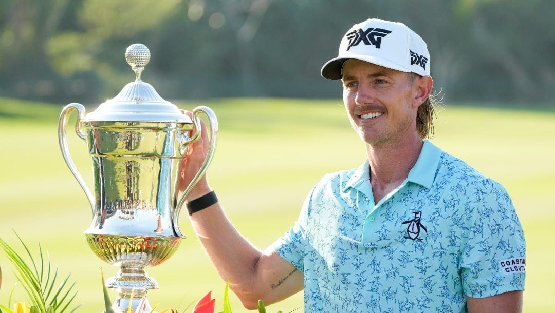 Jake Knapp, of the United States, poses with his trophy during the award ceremony after winning the Mexico Open golf tournament in Puerto Vallarta, Mexico, Sunday, Feb. 25, 2024. (AP Photo/Fernando Llano)