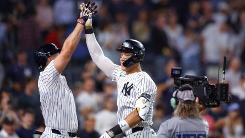 New York Yankees' Aaron Judge, center, celebrates with Giancarlo Stanton, left, after hitting a home run against the Baltimore Orioles during the seventh inning of a baseball game, Thursday, Sept. 26, 2024, in New York.