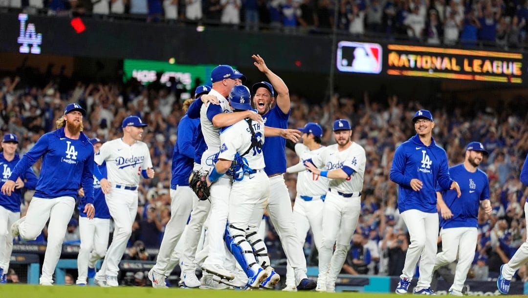 Los Angeles Dodgers pitcher Blake Treinen and catcher Will Smith celebrate their win against the New York Mets in Game 6 of a baseball NL Championship Series, Sunday, Oct. 20, 2024, in Los Angeles.