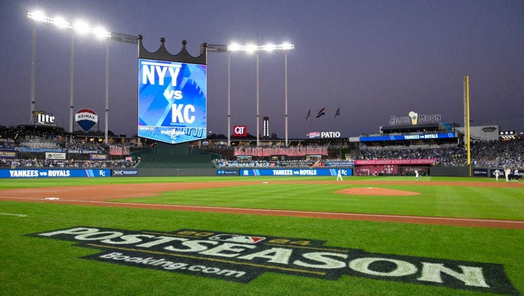 Major League Baseball's postseason logo on the field at Kauffman Stadium before Game 4 of an American League Division baseball playoff series between the Kansas City Royals and the New York Yankees Friday, Oct. 11, 2024, in Kansas City, Mo.