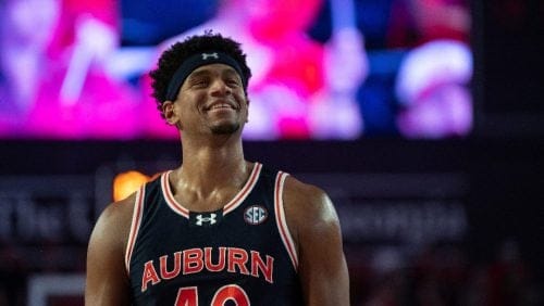 Auburn center Dylan Cardwell (40) smiles while walking down the court during the second half of an NCAA college basketball game against Georgia on Saturday, Jan. 18, 2025, in Athens, Ga.