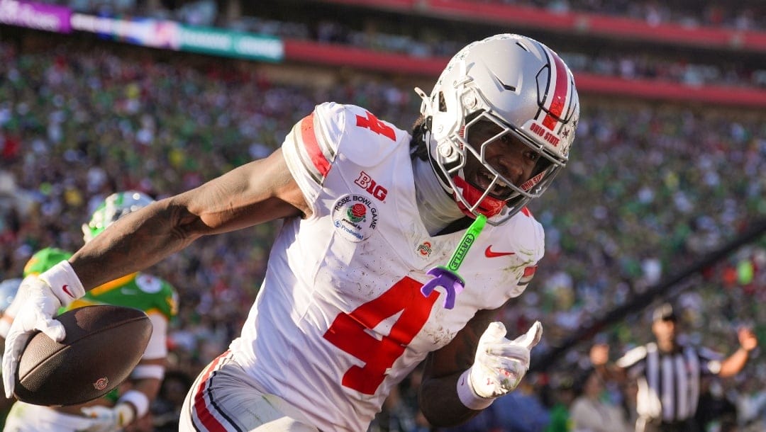 Ohio State wide receiver Jeremiah Smith (4) celebrates his touchdown against Oregon during the first half in the quarterfinals of the Rose Bowl College Football Playoff, Wednesday, Jan. 1, 2025, in Pasadena, Calif.