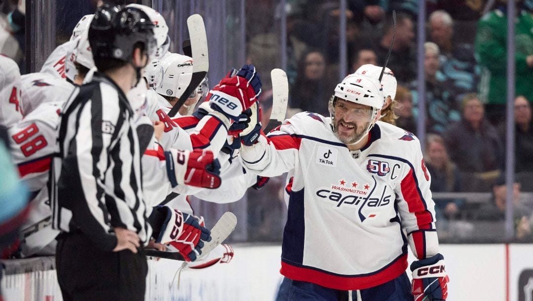 Washington Capitals left wing Alex Ovechkin (8) is congratulated after scoring against the Seattle Kraken during the third period of an NHL hockey game, Thursday, Jan. 23, 2025, in Seattle.