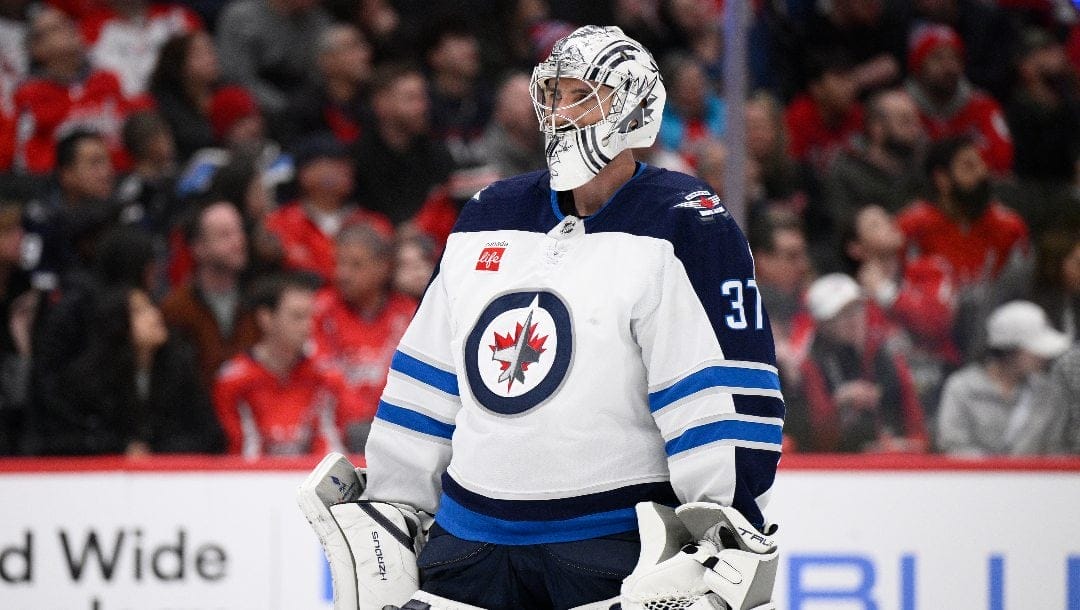 Winnipeg Jets goaltender Connor Hellebuyck (37) looks on during the first period of an NHL hockey game against the Washington Capitals, Saturday, Feb. 1, 2025, in Washington.