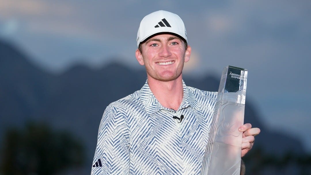 Nick Dunlap holds the trophy after winning the American Express golf tournament, Sunday, Jan. 21, 2024, in La Quinta, Calif. (AP Photo/Ryan Sun)