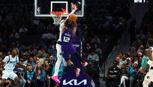 CHARLOTTE, NORTH CAROLINA - JANUARY 20: Daniel Gafford #21 of the Dallas Mavericks defends a shot by Josh Okogie #12 of the Charlotte Hornets during the second half of a basketball game at Spectrum Center on January 20, 2025 in Charlotte, North Carolina. NOTE TO USER: User expressly acknowledges and agrees that, by downloading and or using this photograph, User is consenting to the terms and conditions of the Getty Images License Agreement.