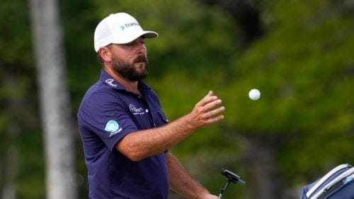 Stephan Jaeger catches a ball from his caddie on the 13th hole during the final round of the Sony Open golf event, Sunday, Jan. 12, 2025, at Waialae Country Club in Honolulu.