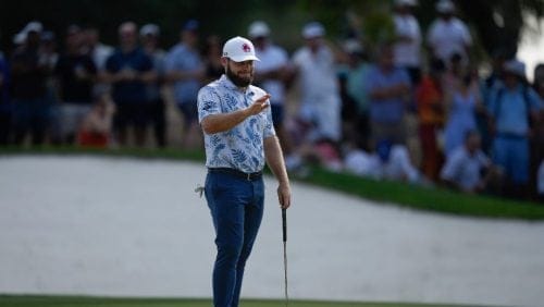 Tyrell Hatton of England reacts after missing a shot on the 5th hole in the final round of World Tour Golf Championship in Dubai, United Arab Emirates, Sunday, Nov. 17, 2024.