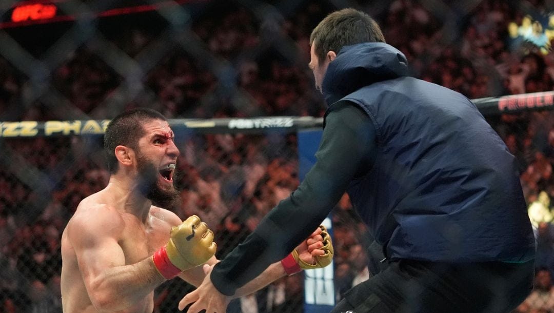 Russia's Islam Makhachev, left, celebrates after beating Dustin Poirier in a lightweight title bout at the UFC 302.