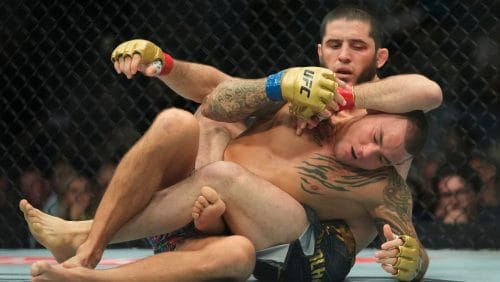 Russia's Islam Makhachev, above, works against Dustin Poirier during the first round of a lightweight title bout at the UFC 302.