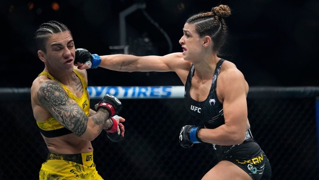 Brazil's Mackenzie Dern, right, punches Brazil's Jessica Andrade during the first round of a women's strawweight bout.