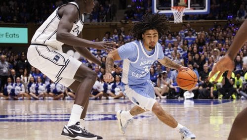 North Carolina's Elliot Cadeau (3) handles the ball as Duke's Khaman Maluach, left, defends during the first half of an NCAA college basketball game in Durham, N.C., Saturday, Feb. 1, 2025.