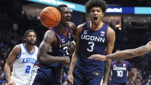 UConn's Samson Johnson, reacts to his dunk with Jaylin Stewart, right, during the second half of an NCAA college basketball game against Xavier, Saturday, Jan. 25, 2025, Cincinnati.