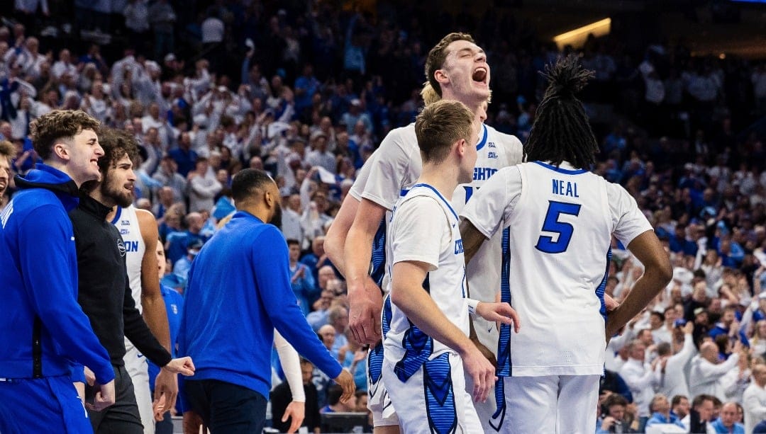 Creighton center Ryan Kalkbrenner (11), center, celebrates with guards Steven Ashworth (1) and Jamiya Neal (5) in a timeout during the first 1half of an NCAA college basketball game, Tuesday, Feb. 11, 2025, in Omaha, Neb. (AP Photo/Bonnie Ryan)