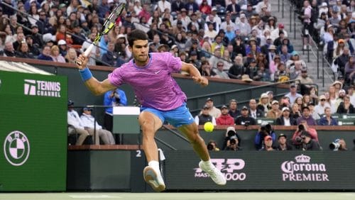 Carlos Alcaraz, of Spain, returns to Jannik Sinner, of Italy, during a semifinal match at the BNP Paribas Open tennis tournament, Saturday, March 16, 2024, in Indian Wells, Calif.