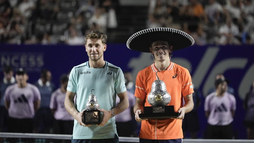 Alex de Minaur of Australia, right, and Casper Ruud of Norway pose with thier trophies after the final match of the Mexican Open tennis tournament in Acapulco, Mexico, Saturday, March 2, 2024.