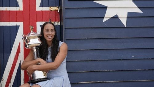 Madison Keys of the U.S. holds the Daphne Akhurst Memorial Cup at the Brighton Beach Boxes the morning after defeating Aryna Sabalenka of Belarus in the women's singles final at the Australian Open tennis championship in Melbourne, Australia, Sunday, Jan. 26, 2025.