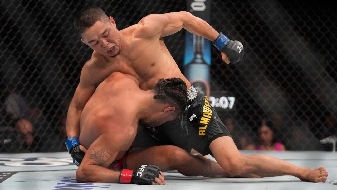 Asu Almabayev, top, strikes CJ Vergara during a UFC 299 mixed martial arts bout, Saturday, March 9, 2024, in Miami.