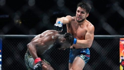 Henry Cejudo, right, grapples with Aljamain Sterling, of Jamaica, during the third round of a bantamweight title bout.