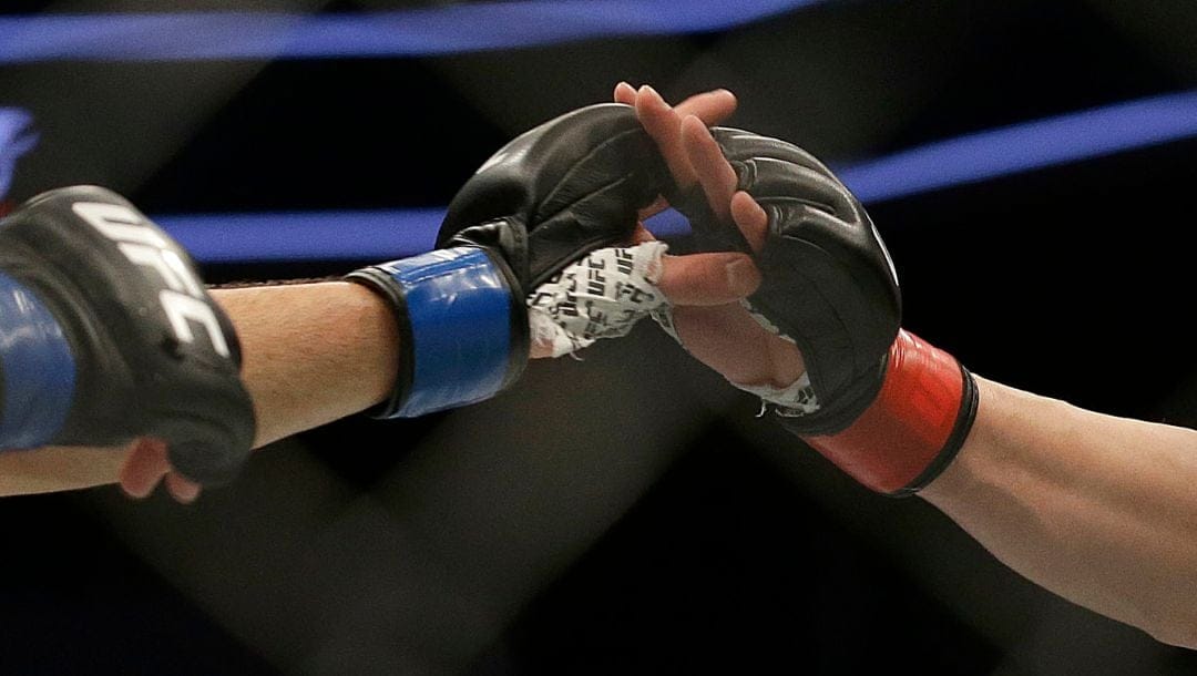 Sage Northcutt, right, touches gloves with Mickey Gall during a UFC Fight Night mixed martial arts fight in Sacramento, Calif.