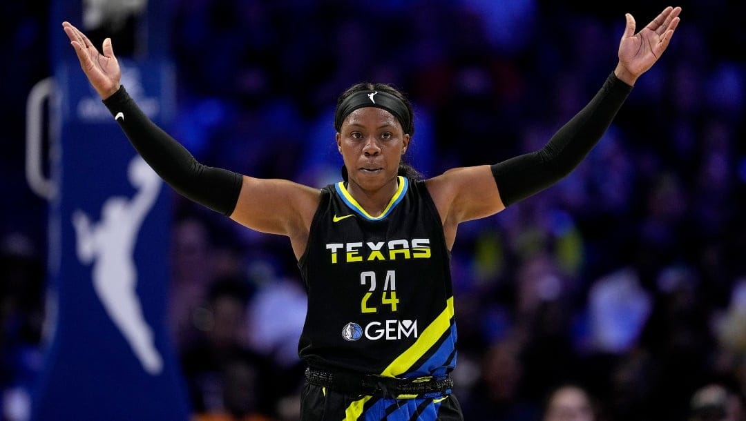 Dallas Wings guard Arike Ogunbowale motivates fans in the second half of a WNBA basketball game against the Indiana Fever, Sunday, Sept. 1, 2024, in Arlington, Texas.