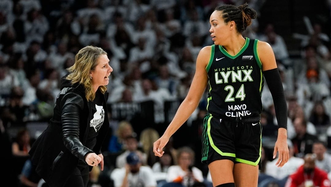 Minnesota Lynx head coach Cheryl Reeve talks to forward Napheesa Collier (24) during the second half of Game 4 of a WNBA basketball final playoff series, Friday, Oct. 18, 2024, in Minneapolis.