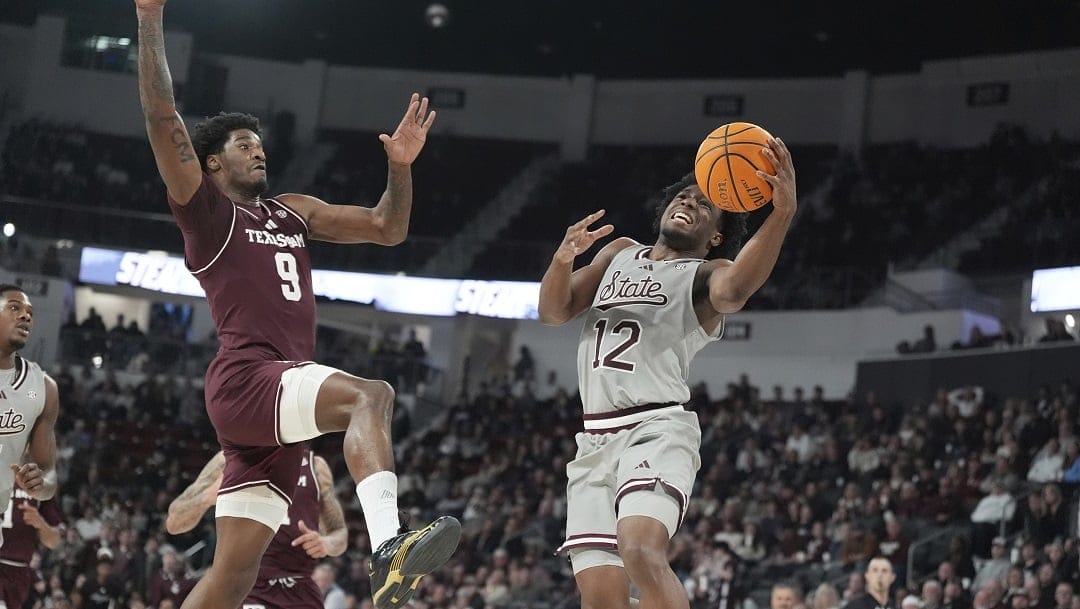 Mississippi State guard Josh Hubbard (12) attempts to make a layup while Texas A&M forward Solomon Washington (9) leaps up to defend during the second half of an NCAA college basketball game, Tuesday, Feb. 18, 2025, in Starkville, Miss.