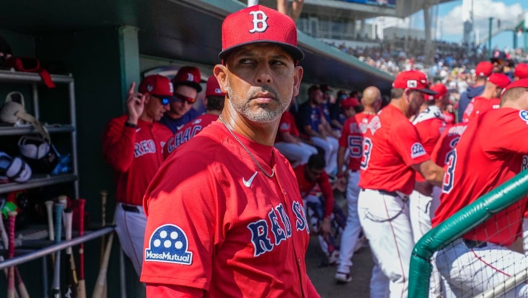 Boston Red Sox manager Alex Cora watches from the dugout in the second inning of a spring training baseball game against the Tampa Bay Rays in Fort Myers, Fla., Wednesday, Feb. 26, 2025.
