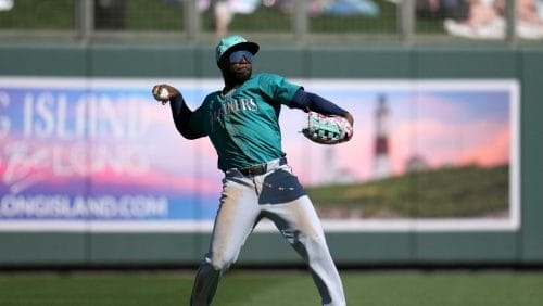 Seattle Mariners left fielder Randy Arozarena throws to the infield during the third inning of a spring training baseball game against the Colorado Rockies Sunday, March 2, 2025, in Scottsdale, Ariz.