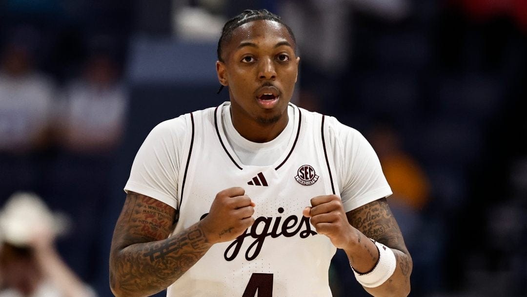 Texas A&M guard Wade Taylor IV (4) reacts ti his three-point shot against Texas during the second half of an NCAA college basketball game in the second round of the Southeastern Conference tournament, Thursday, March 13, 2025, in Nashville, Tenn.