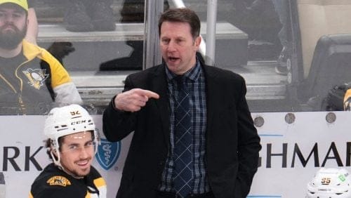 Boston Bruins interim head coach Joe Sacco gives instructions from behind his bench during the third period of an NHL hockey game against the Pittsburgh Penguins in Pittsburgh, Sunday, April 13, 2025.